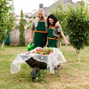 Couple-With-Flower-Harvest-In-Wheelbarrow