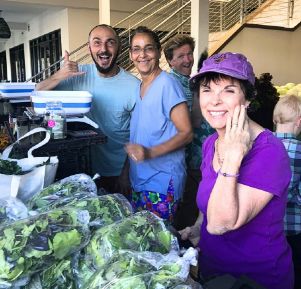 Candid-Of-Dr-Carolyn-Dean-With-Farmers-Market-Volunteers-And-Okoa-Owner