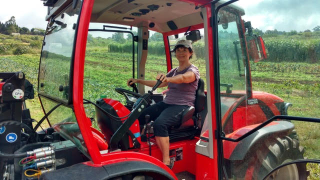 Carolyn-Dean-in-specialty-Italian-Tractor-her-First-Purchase-For-Okoa